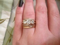 a woman's hand with two rings on it