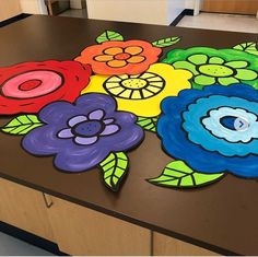 a table with flowers painted on it