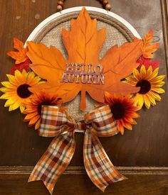 an autumn wreath with sunflowers and leaves on the door hanger that says hello autumn