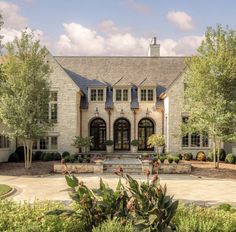 a large house with lots of windows and landscaping