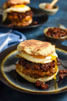 an egg sandwich with bacon and cheese on a plate