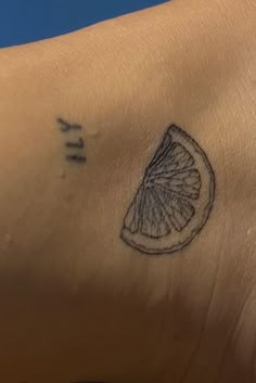 a close up of a person's arm with a tattoo on the left side