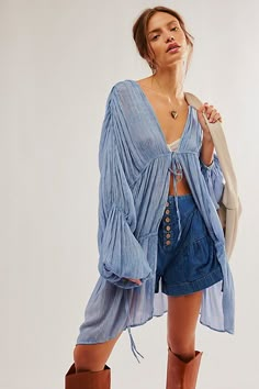 Add the loveliest layer to any look with this so cool kimono featured in a drapey, tiered design and pleated fabrication with exaggerated, billowy sleeves for added shape. **Features:** Relaxed fit, front-tie closure, pleated style, elasticated detail at wrists **Why We ❤ It:** Sure to be a go-to throw-on-and-go staple from season to season. **Fit Note:** This style may small, so we recommend sizing up if a more oversized, slouchy fit is desired. | Juliet Kimono by Free People in Blue