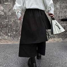 From Tokyo Streets to City Chic: Hakama that Makes a Statement Unleash the boldness of tradition with our Japanese Style Statement Hakama. Crafted for the modern trailblazer, this garment is a testament to timeless elegance fused with contemporary flair. The fluid, wide-leg design makes a dramatic statement, ideal for those who dare to stand out. Our Asymmetric Hakama pants are adorned with a minimalist bamboo print, elegantly cascading down each leg, set against a stark black background that en Modern Kimono Dress, Mens Wide Leg Pants, Japanese Pants, Hakama Pants, Tokyo Streets, Japanese Uniform, Sukajan Jacket, Japanese Socks, Bamboo Print