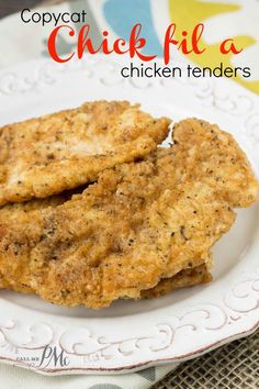 two chicken tenders on a white plate with green border and text that reads copycat chick fil a chicken tenders