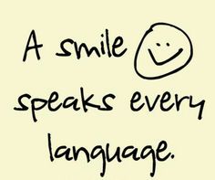 the words smile speaks every language on a white background with black lettering and an image of a