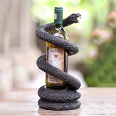 a snake wrapped around a bottle of wine