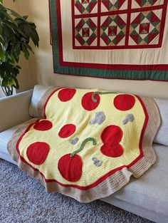 a blanket that has been made to look like a piece of pizza on a couch