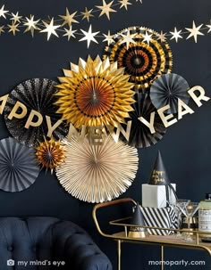 a black wall decorated with gold and silver paper fan decorating it's new year