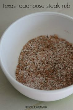 a white bowl filled with spices on top of a table