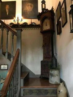 an old grandfather clock sitting on top of a set of stairs