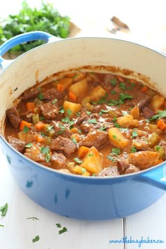 a blue pot filled with stew on top of a table