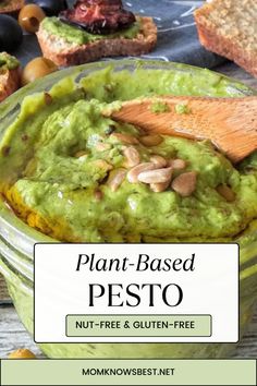 a jar filled with pesto next to bread