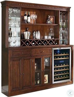 a wooden bar with wine glasses and bottles on it's front shelf, next to an empty glass cabinet