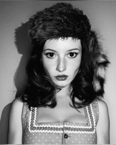 black and white photograph of a woman wearing a fur hat