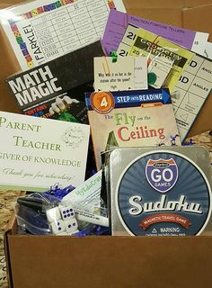 an open box filled with lots of different types of games and books on top of a table