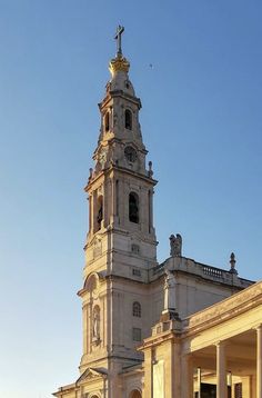 a large white building with a clock on it's side and a tower at the top