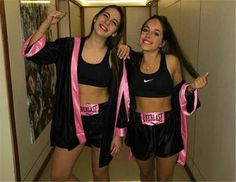 two women in matching outfits posing for the camera