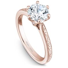 a rose gold engagement ring with an engraved band