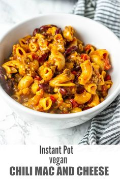 a white bowl filled with chili macaroni salad on top of a marble counter