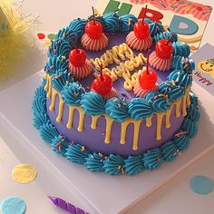 a birthday cake with blue icing and colorful decorations