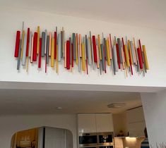 the wall is decorated with many different colored sticks