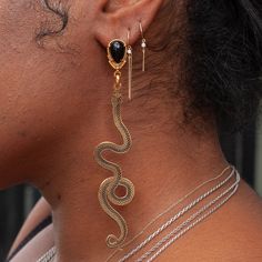 Slither up, slither down. A pair of golden snakes dangle asymmetrically in a pair of statement earrings in gold plating & enamel. Handmade by La Libertad in their Colombia Studio. Golden Snake, Welding Shop, Stacking Bands, Earrings In Gold, Enamel Earrings, Snakes, Piercing Jewelry, Earring Necklace, Gold Plating