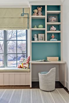 a room with blue walls and shelves filled with stuffed animals on top of bookshelves