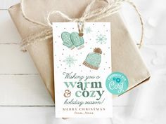 a christmas gift tag that says, wishing you a warm and cozy holiday season with mittens on it