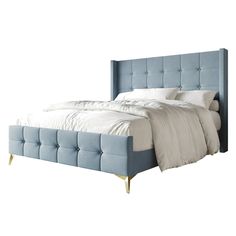 a bed that is made up with white sheets and blue headboard on top of it