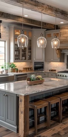 a large kitchen with wooden floors and gray cabinets