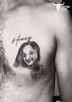 a man with a tattoo on his chest that reads honey and has an image of a woman's face