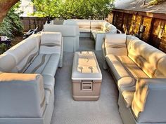 an outdoor living area with couches and tables