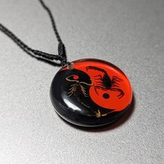 Our beautifully crafted Scorpion necklace is amazingly beautiful. Our unique necklace contains real scorpion remnants in a nice yin-yang necklace pendant. This wonderful scorpion inspired necklace is made to last a lifetime. Includes a comfy chain design to fit comfortably when on the neckline. Made of resin, our one of a kind necklace will be your all-time favorite accessory. Get yours today. Sold & Shipped by Pins & Bones, a leading alternative fashion brand. Pins & Bones Scorpion YinYang Neck Scorpion Fashion, Scorpion Jewelry Aesthetic, Scorpion Necklace, Scorpio Jewelry Necklaces, Scorpion Jewelry, Scorpion Earrings, Yin Yang Necklace, Dark Jewelry, Scorpion