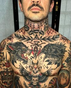 a man with lots of tattoos on his chest and chest is looking at the camera