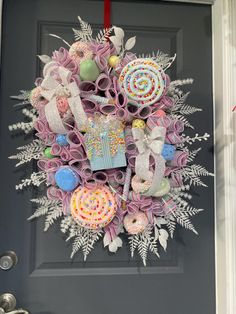 a wreath made out of toilet paper and other items hanging on the front door to celebrate someone's birthday