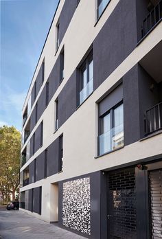 an apartment building with black and white designs on the side