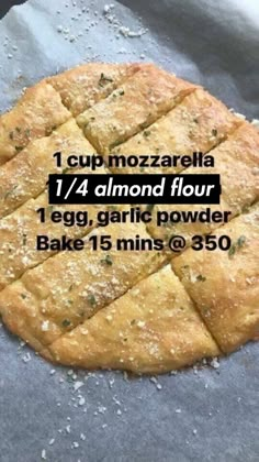 a pizza sitting on top of a table covered in floured dough and toppings