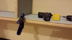 two cameras sitting on top of a shelf