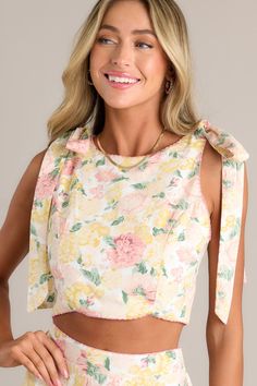 Introducing our Garden Harmony Ivory Floral Crop Top - the perfect addition to your summertime wardrobe! With its beautiful floral design. this top will add a touch of elegance to your outfit. Enjoy the comfort and style with this playful and stylish piece. This ivory crop top features a rounded neck. self-tie shoulder features. 3 functional buttons down the back. cutouts. no boning in the bodice (while still keeping the bustier look). and subtle scallop trim. 100% Rayon Lined 100% Rayon Hand Wash Cold Manufactured in China Designed in the USA Model is wearing a size small China Design, Scallop Trim, Floral Crop Tops, Red Dress, Bodice, Floral Design, Crop Top, Trim, Crop Tops