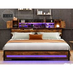 a bed with a wooden headboard and purple lights on the night stand above it