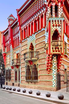 the building has many windows and balconies on it's sides, along with decorative railings