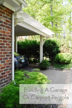 a car parked in front of a brick building with trees and bushes around the entrance