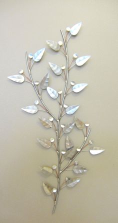 a metal wall decoration with leaves on it