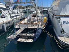 several boats are docked in the water near each other