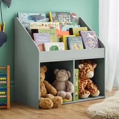 a book shelf with stuffed animals and books on it in a child's room