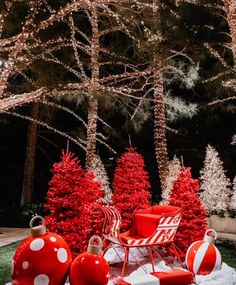 red and white christmas decorations in front of trees