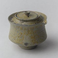 an old ceramic tea pot with a lid