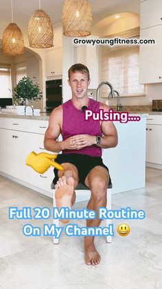 a man sitting on top of a kitchen counter next to a yellow blow dryer