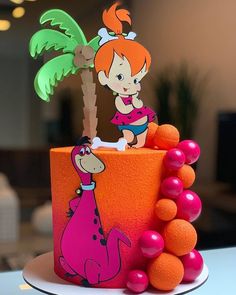 there is a cake decorated to look like a cartoon character with a palm tree on top